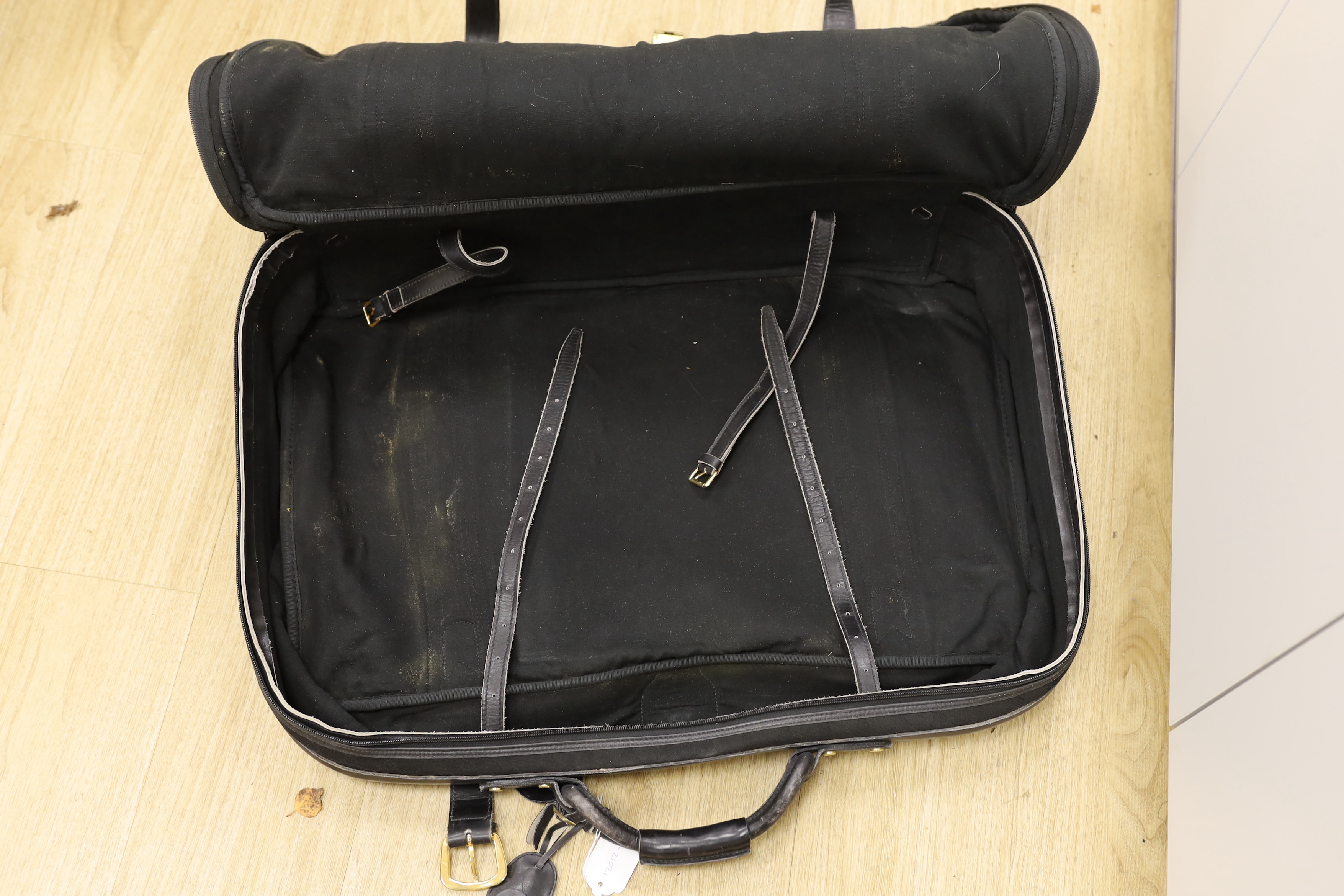 A black fabric and leather trimmed Gucci suitcase